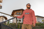 Guy with sunglasses wearing super driven legend  sunset orange motivational eco-friendly hoodie