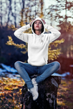 girl wearing super driven bee focused arctic white hoodie in  woods looking upwards