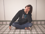 Girl sitting on the floor with her hand on her face wearing super driven black obsession eco-friendly motivational hoodie 