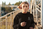 girl with pink headphones running in her black super driven  future billionaire motivational crop hoodie  a great present for entrepreneurs 